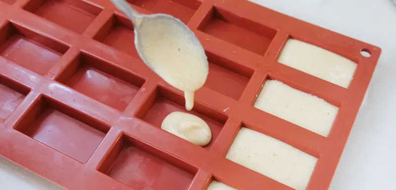 Spoon or pipe the biscuit batter into the moulds